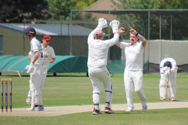 Billy Higgins, playing his first Pocklington 1st XI game of the season, is congratulated by skipper and wicket-keeper, Joel Taylor, after taking the second of his three wickets. Photo by Phil Gilbank