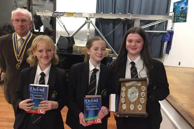 Rotary Club of Whitby & District President, Bob Cameron, presents the winning Caedmon team with their trophy and prizes.