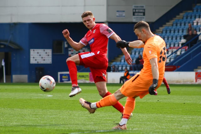 Jake Charles tries to charge down a clearance by Telford's keeper.
