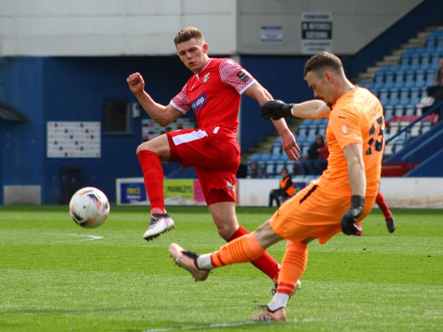 Jake Charles tries to charge down a clearance by Telford's keeper.