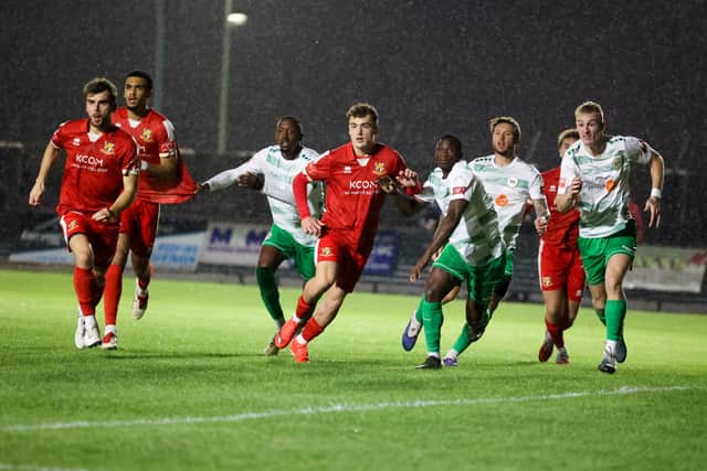 The two sides battle it out at a soaked Queensgate. Photo by ECmedia