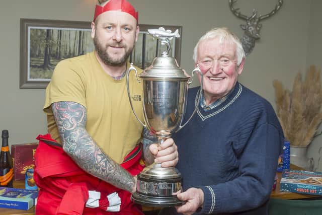 Rob Taylor is presented with his trophy by WSAA Chairman William Atkinson after his Christmas match win. Photo by Peter Horbury