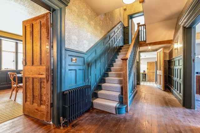 The hallway, with oak staircase and panelled walls.
