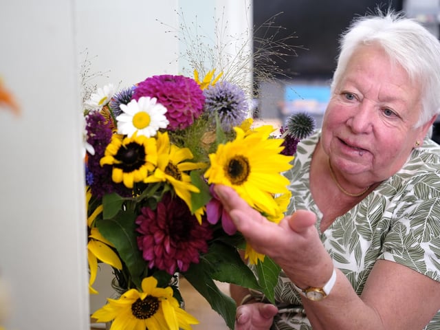 Sue Butler views the lovely flowers.