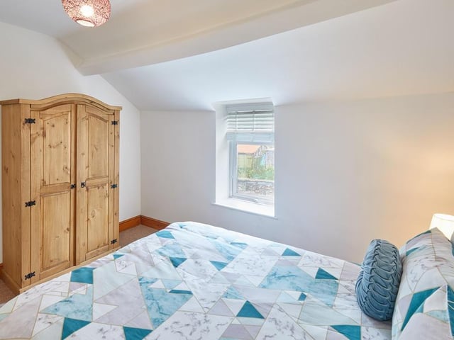 The main bedroom has plenty of storage space thanks to a wardobe and bedside drawers