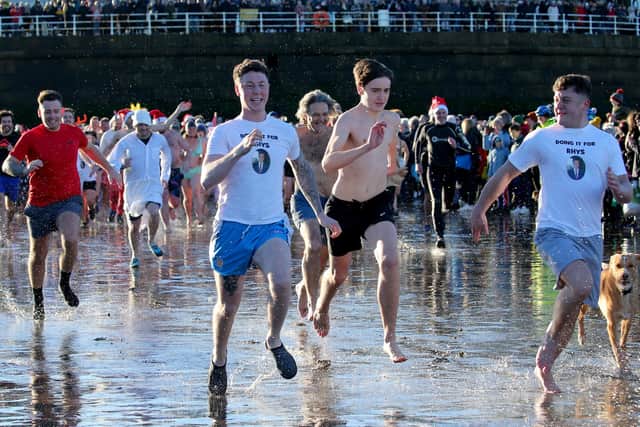 Racing into the North Sea at Whitby Boxing Day dip 2023. picture: Brian Murfield