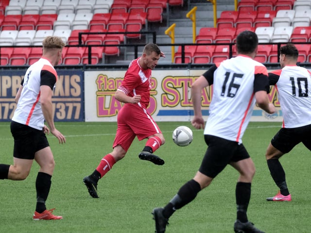 A Newlands player looks to weave his way past Rovers players