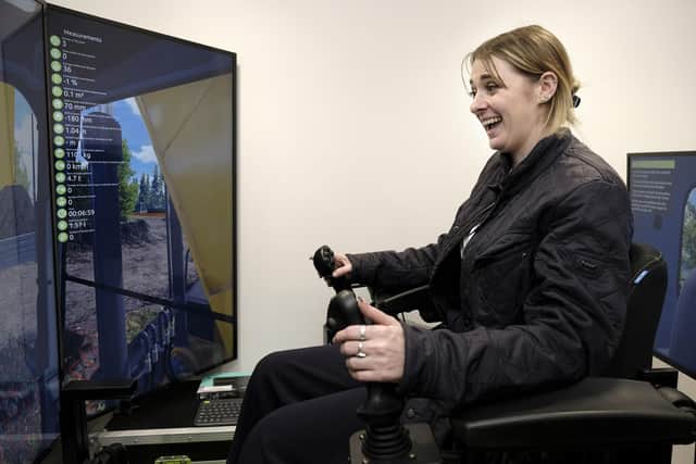 Ms Davison at the controls of a virtual reality excavator