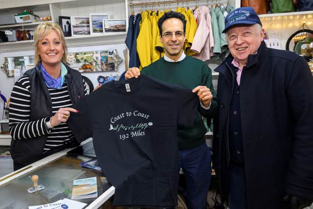 The owner of the Old Drapery in Robin Hood’s Bay, Holly Gray, with the chairman of North Yorkshire Council, Cllr George Jabbour, and the leader of North Yorkshire Council, Cllr Carl Les. Coast to Coast Path participants regularly pop into the shop to buy commemorative keepsakes.