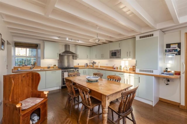 The beamed dining kitchen, with fitted units and some integrated appliances.