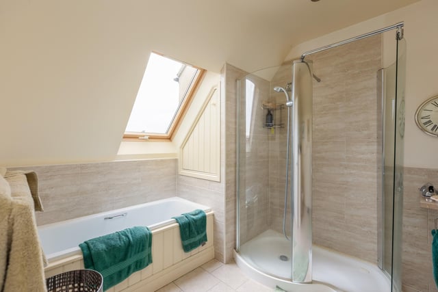 This bathroom includes both a bath and a shower cubicle.