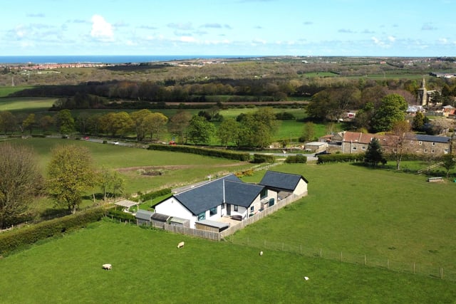 An aerial view of the property that has views right over to the coast.