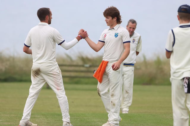 Sewerby CC congratulate the bowler after taking an Ebberston wicket.