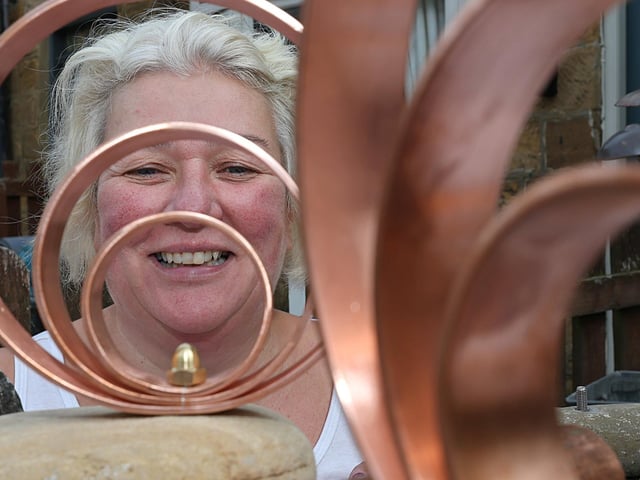 Artist Sarah Cutts with a sculpture. photo: Richard Ponter