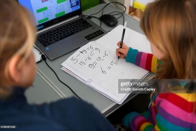 A youngsters does her Maths studies in her bedroom. Photo by Gareth Copley/Getty Images
