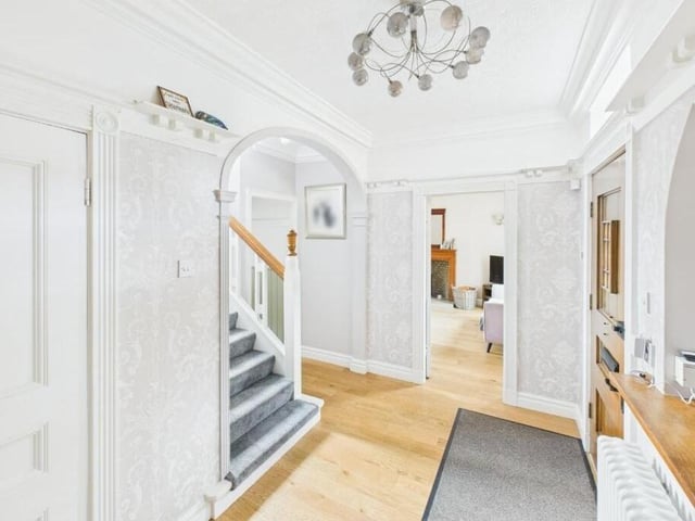 A bright and welcoming hallway with staircase up.
