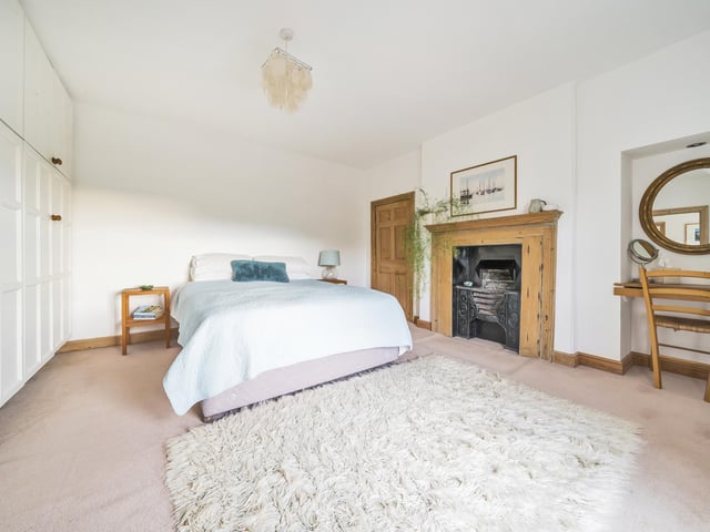 One of three double bedrooms with feature fireplaces within the farmhouse.