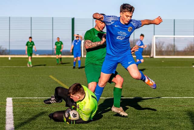 Whitby Fishermen's Society Development keeper Harry Clarke gathers the ball safely, with his defender Lucas Carrington in close attendance. Photo by Brian Murfield
