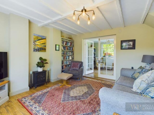 The beamed lounge opens through to a garden room.