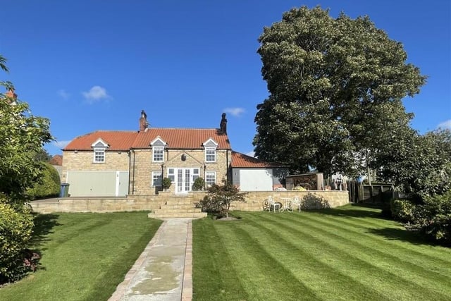 There are lawned gardens to the front, and a rear courtyard garden.