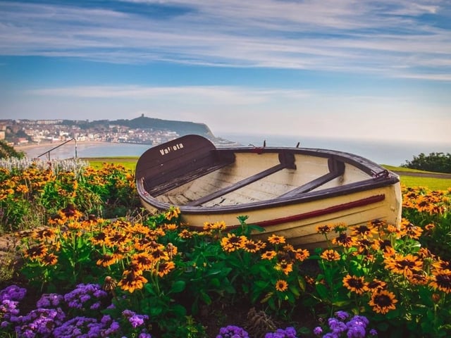 A boat with a stunning Scarborough back drop.