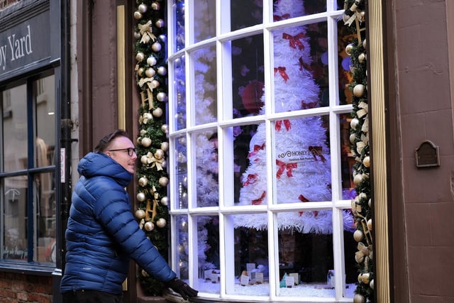 Admiring the festive window at Honeyz on Church Street.
picture: Richard Ponter, 225203b