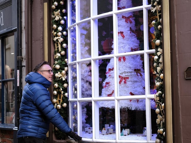 Admiring the festive window at Honeyz on Church Street.
picture: Richard Ponter, 225203b