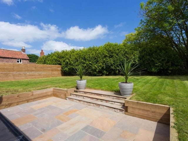 The private lawned garden to the rear has a large patio area.
