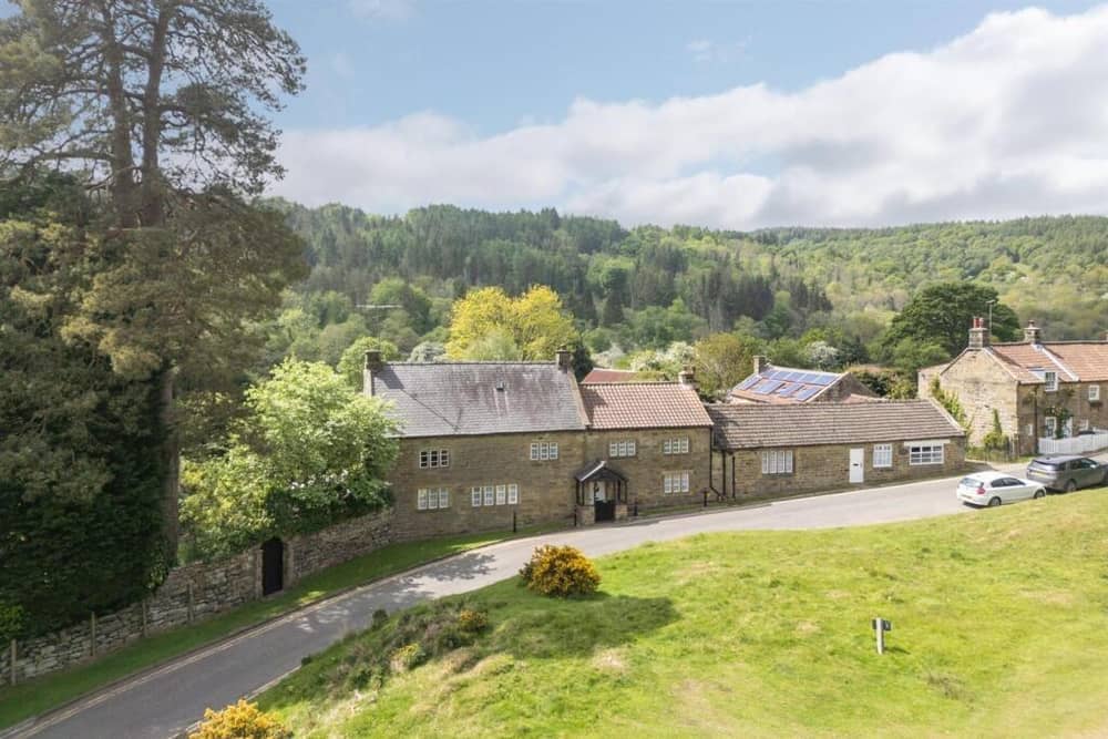 A front view of the appealing home that has extensive private gardens.