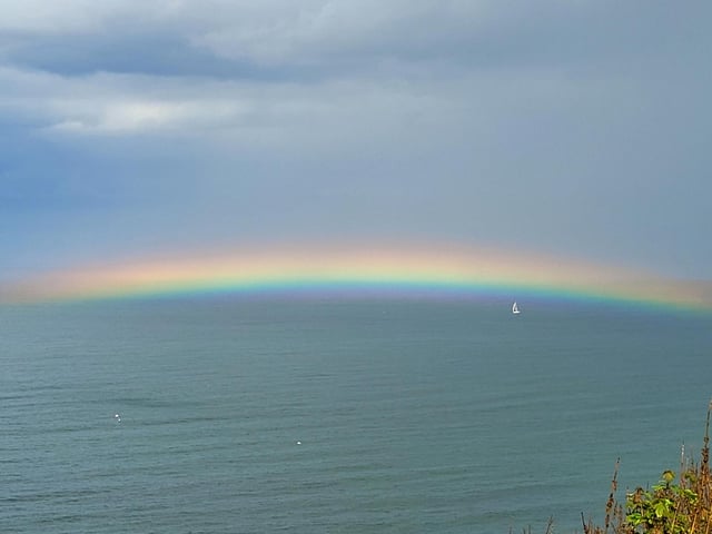 A pretty rainbow stretches across the sea at Scarborough, by Coralie McGrath.