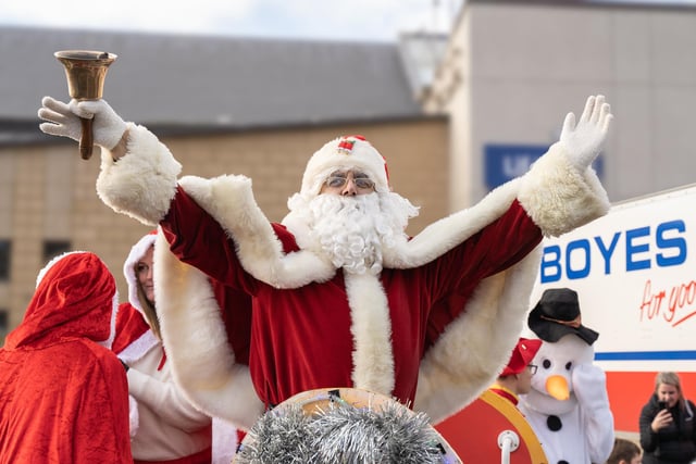 Santa Claus waves to families and children as he arrives in Scarborough.