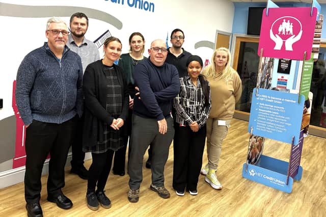 Matthew Stevens (centre), CEO of HEY Credit Union, is pictured with colleagues.
