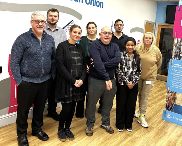 Matthew Stevens (centre), CEO of HEY Credit Union, is pictured with colleagues.