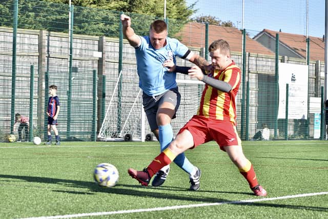 Langtoft look to get the ball away from Millau.