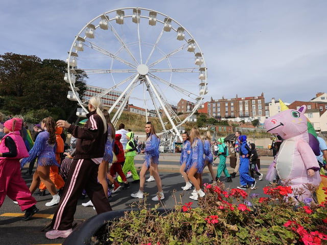 The parade goes past the Big Wheel.