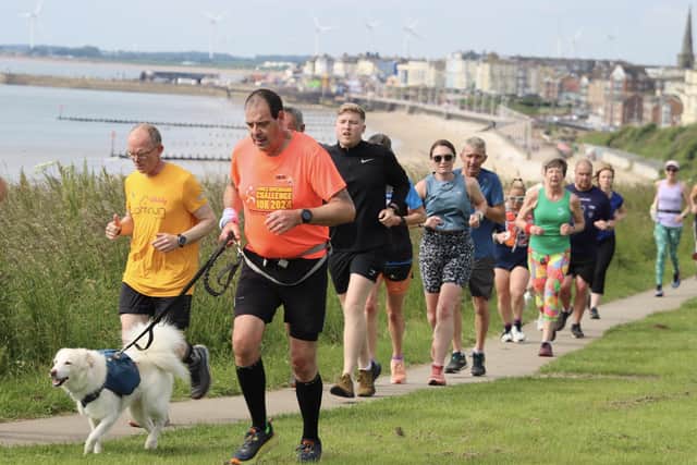 Brid Road Runner Stuart Gent and dog Jasper take the lead along the clifftops.