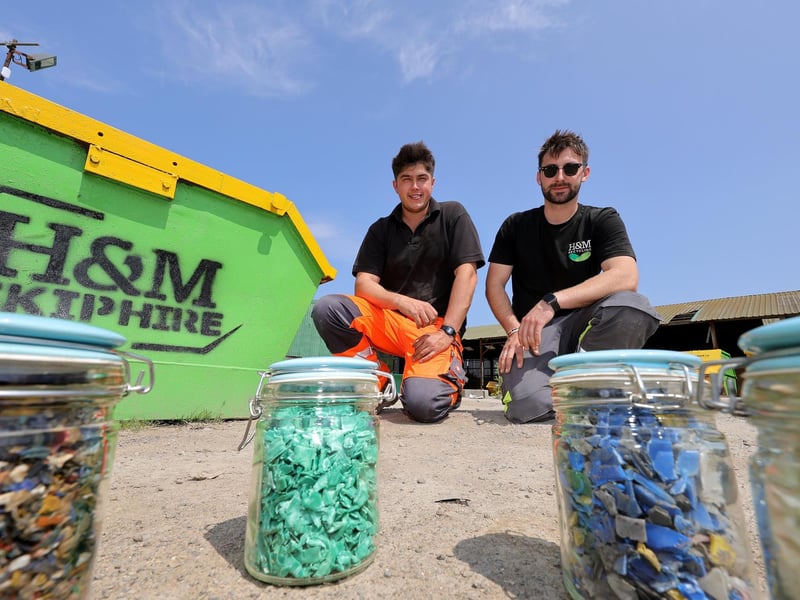 Edward Medforth and Henry Harrison at their recycling site with recycled plastics