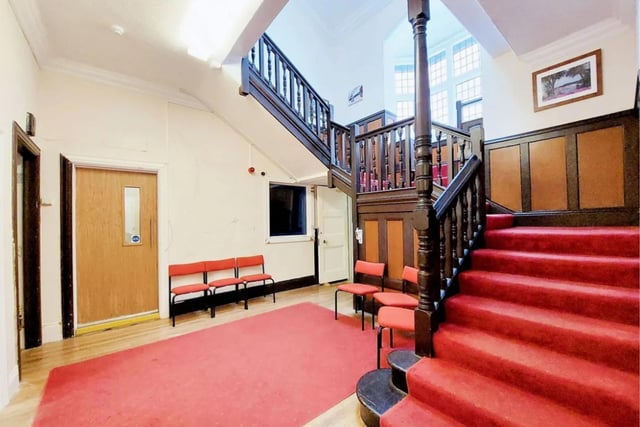 The central hallway features an attractive staircase with bay window at the half landing.