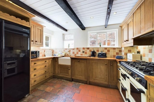 A beamed country kitchen with handmade oak wall and base units.