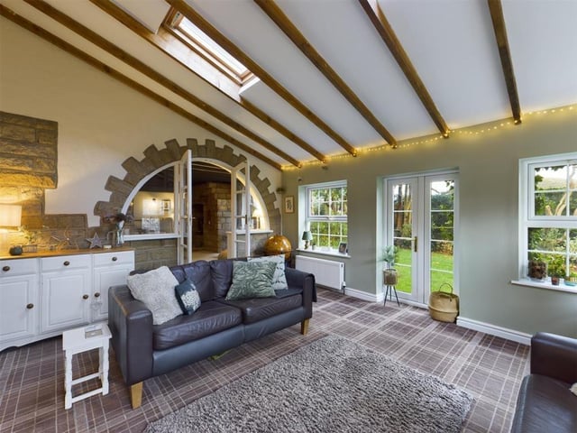 A decorative archway links rooms within the modern yet rustic interior.