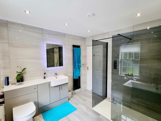 A contemporary style bath and shower room.