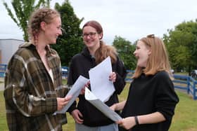 St Augustine's School students Emma Brown, Lucy Raven and Olivia Redfern discuss their results.