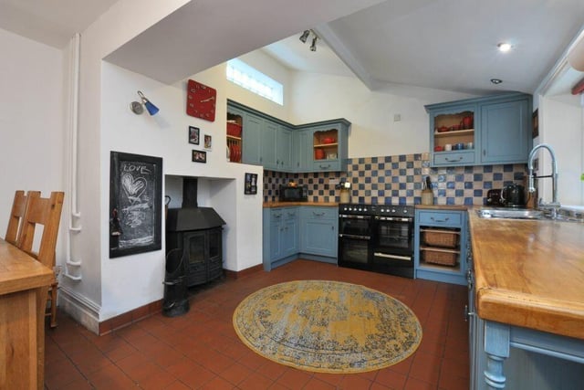The farmhouse kitchen has fitted units with oak worktops, and a quarry tiled floor.