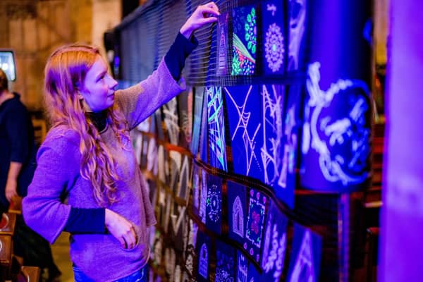 Liberty Ingham, the daughter of the artist in residence at St Mary’s Church, Petra Ingham, looks at some of the artwork that was produced during a community workshop centred on the installation by international artist Peter Snijder.