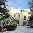 A view of West End House from its leafy garden.