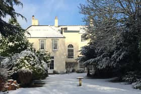 A view of West End House from its leafy garden.