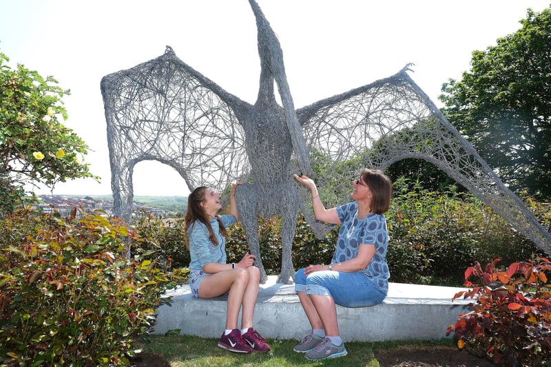 Grace and mum Kellie Simpson meet one of the dinosaur sculptures at Pannett Park.
picture: Richard Ponter