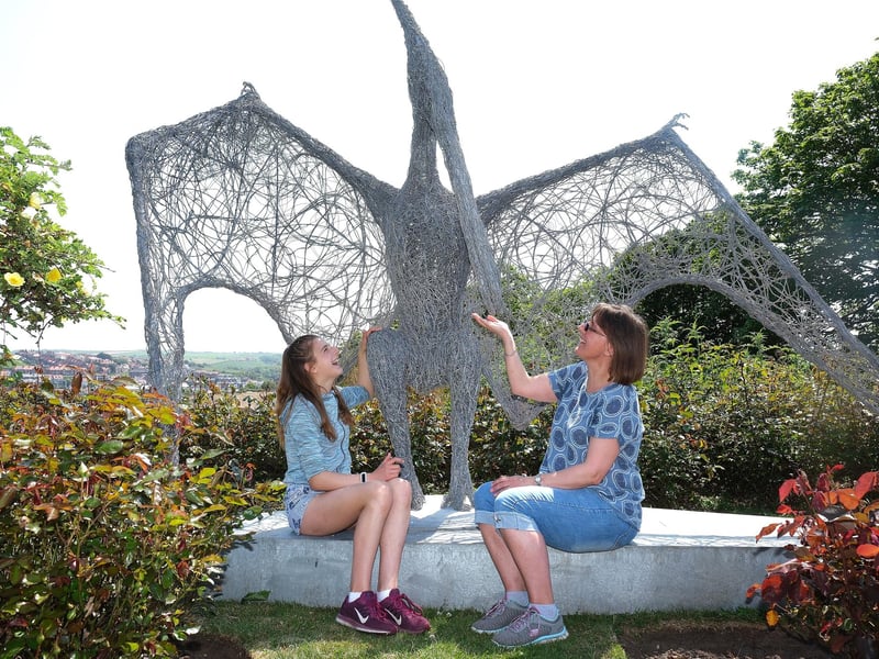Grace and mum Kellie Simpson meet one of the dinosaur sculptures at Pannett Park.
picture: Richard Ponter
