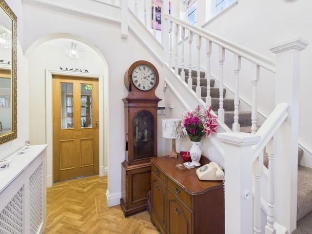 A welcoming hallway with turned staircase leading up.