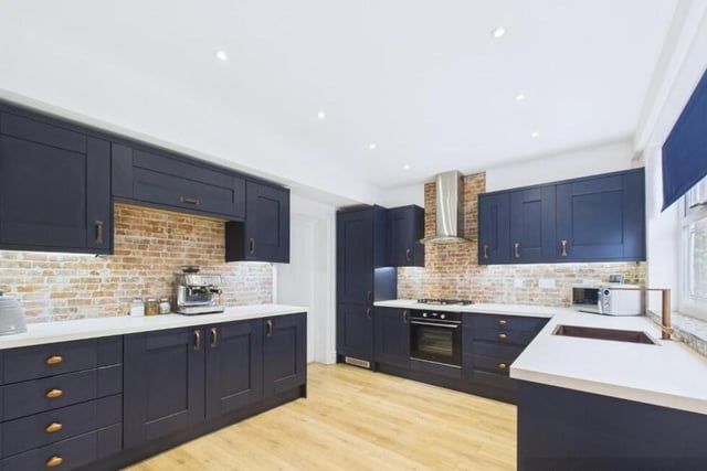 The new, navy kitchen has integrated appliances.